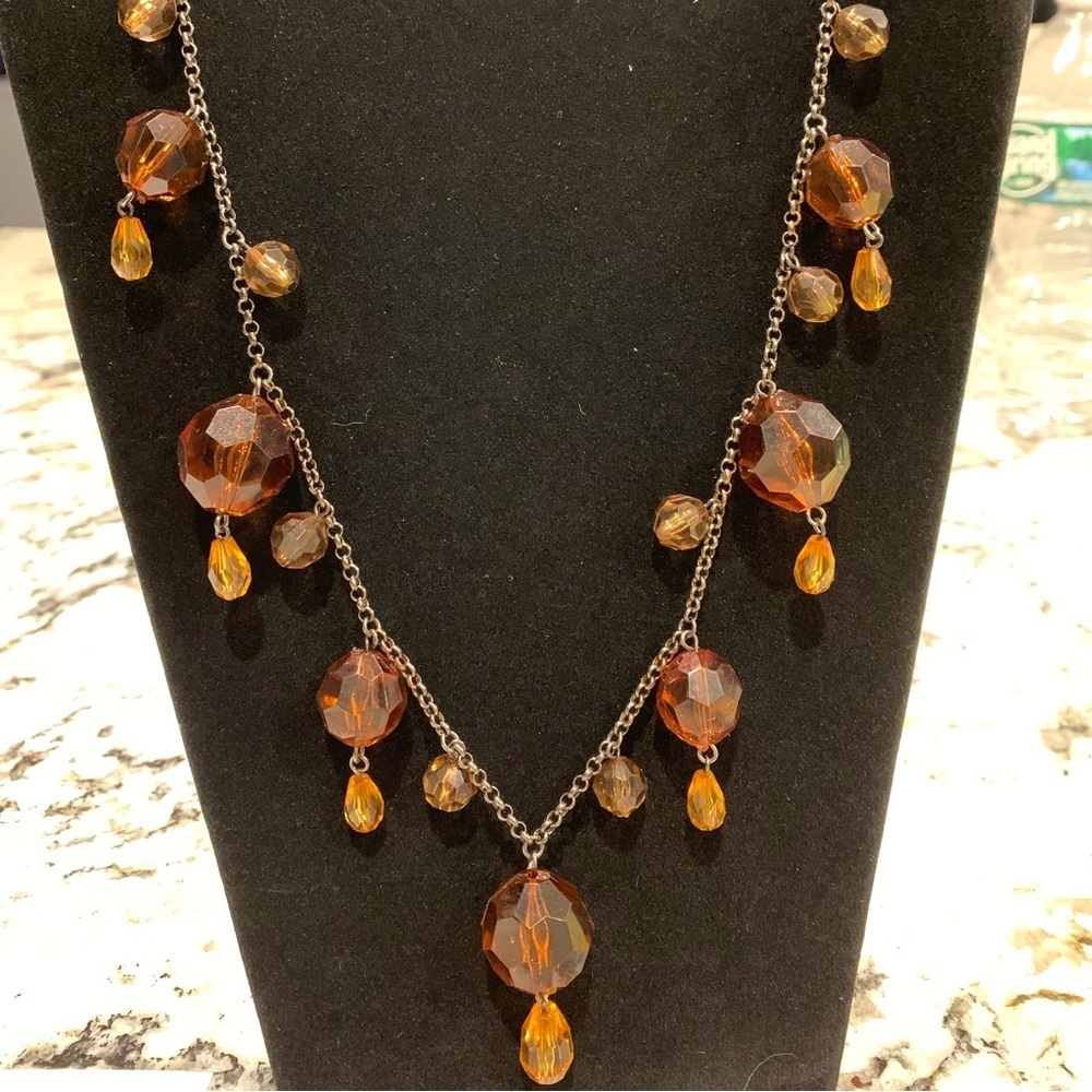 Amber colored glass beaded necklace on gray/silver toned chain